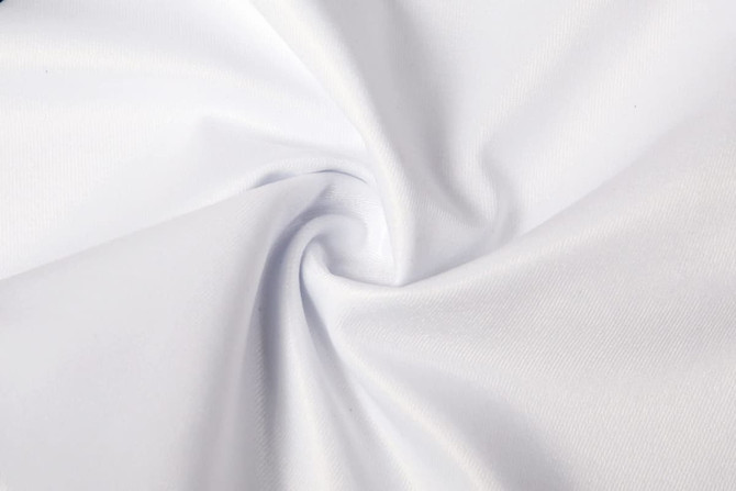 A white fabric with a smooth texture, arranged in a spiral pattern, showcasing its lightweight quality.