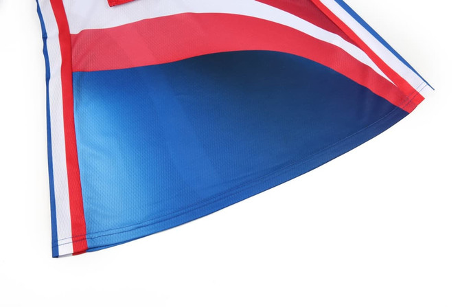 A vibrant netball dress featuring red, blue, and white sections, with a logo on the fabric.