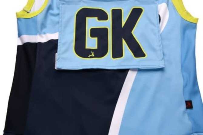Custom netball bib in blue and navy, featuring a green logo and ‘GK’ designation on the back.