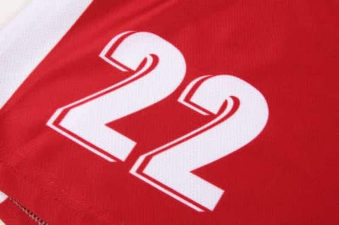 A red soccer uniform featuring white accents and the number 22. The fabric has a sporty texture.