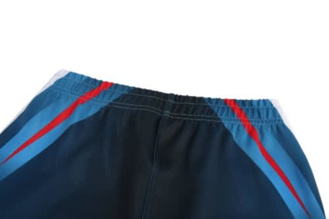 A rugby team wear shorts in navy with red and blue stripes, featuring an elastic waistband and a logo.