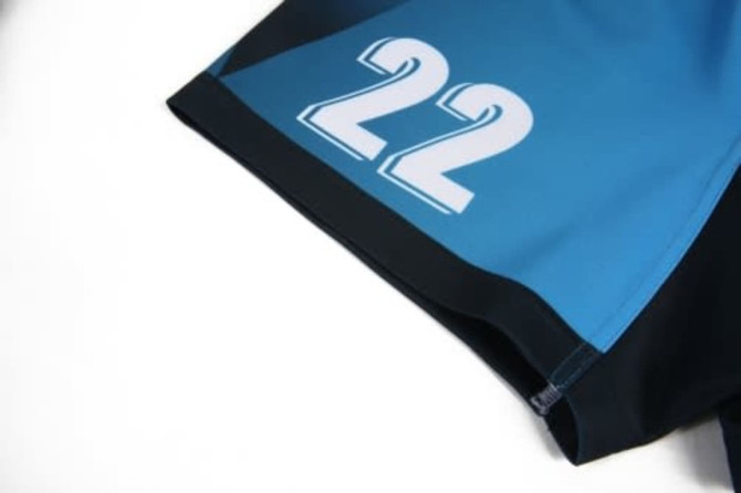 A sports jersey featuring a blue and black design with the number 22 prominently displayed. It has a logo on it.
