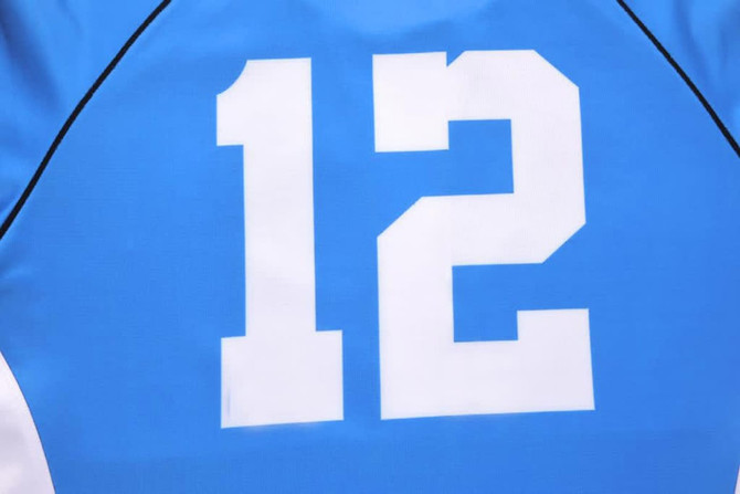 A blue rugby tee featuring a large white number 12 on the front, with black trim detailing.