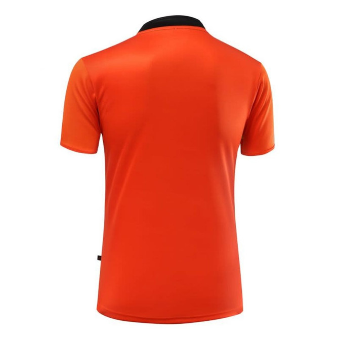 An orange rugby tee with a black collar, featuring a logo on the back.