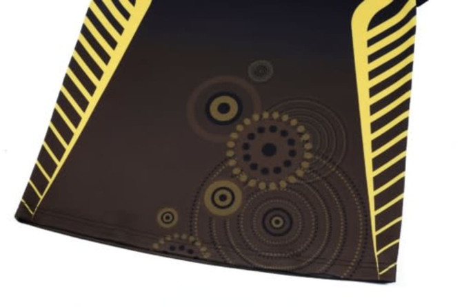 A black rugby top featuring yellow stripes and a circular pattern design in shades of brown and yellow.