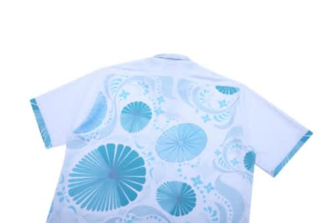 A white shirt with a blue paisley pattern on the back, featuring various circular designs and floral motifs.