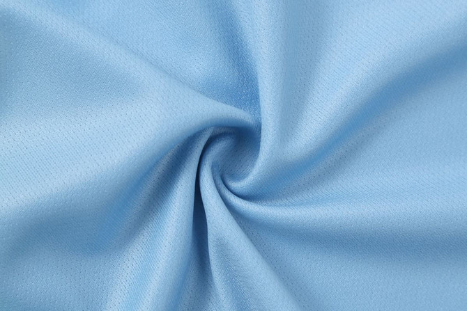 A light blue fabric in a swirling pattern, featuring a smooth texture. Suitable for athletic wear, with a subtle sheen.