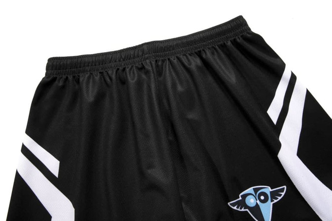 Black volleyball shorts featuring white stripes and a logo on the lower section.