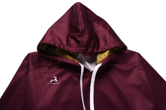 A maroon hoodie with a contrasting yellow inner lining and a white drawstring. It features a logo on the front.