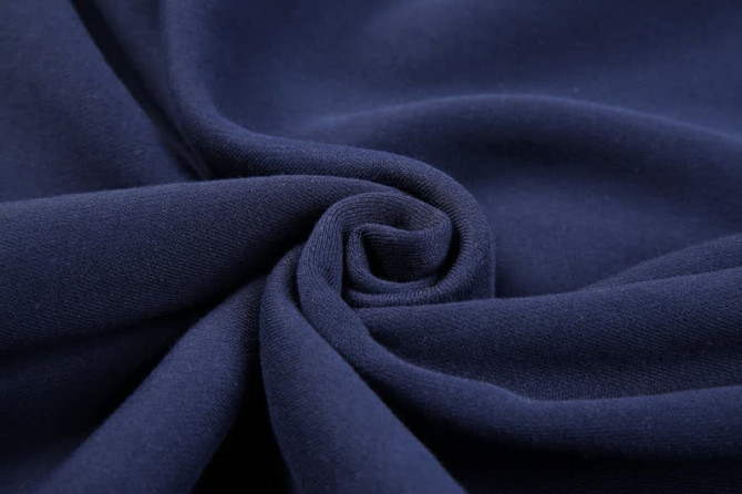 A close-up view of dark navy fleece fabric, showcasing its soft texture and smooth finish.