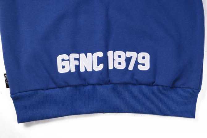 A blue polar fleece hoodie featuring a white logo and text at the bottom. It has a snug fit at the waist.