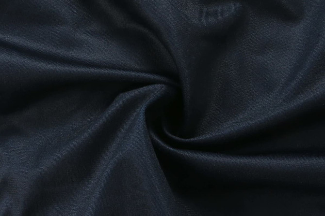 A dark navy fabric with a smooth texture, featuring a swirl pattern.