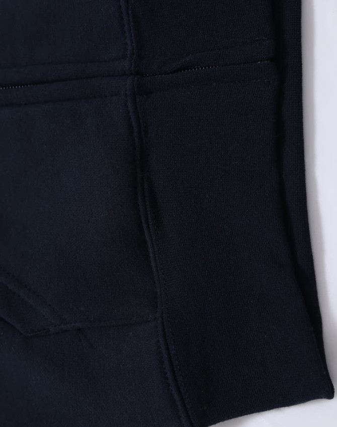 A black kid's full-zip fleecy hoodie featuring a kangaroo pocket and a smooth texture. It has a logo detail.