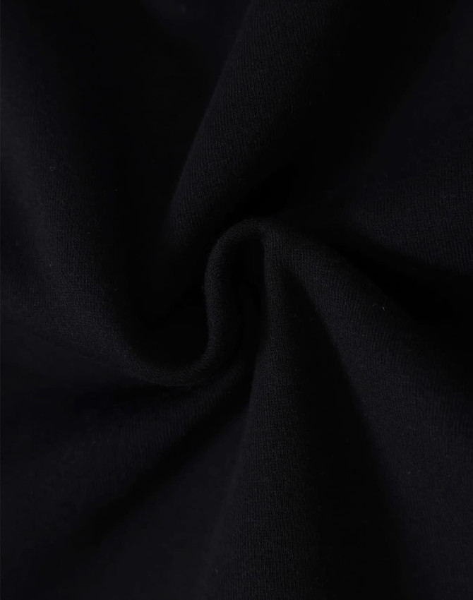 A close-up of black fleecy fabric, showcasing the soft texture and swirl pattern.