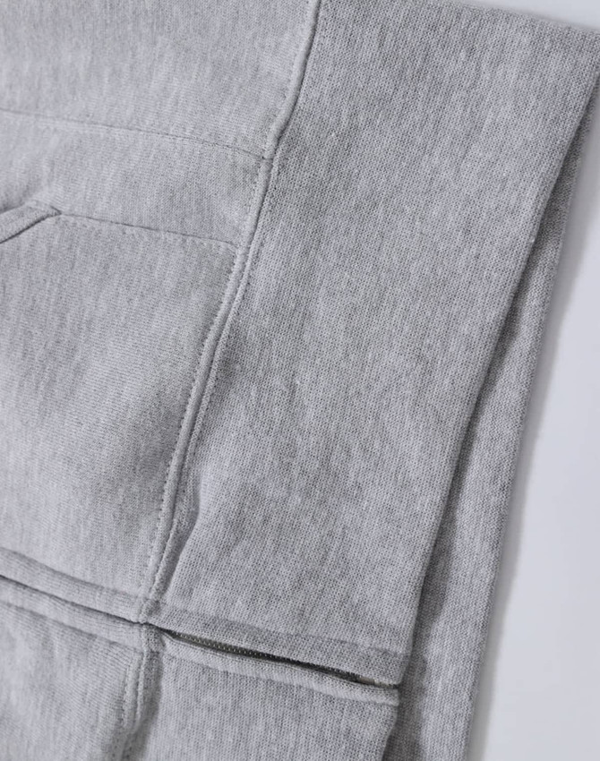 A grey full-zip fleecy hoodie featuring a pocket and a logo. Ideal for casual wear.