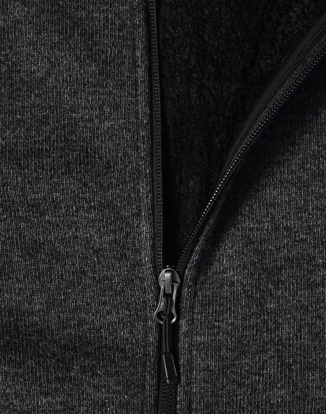 A ladies' grey bonded fleece jacket featuring a zip closure and soft inner lining. It includes a logo on the fabric.