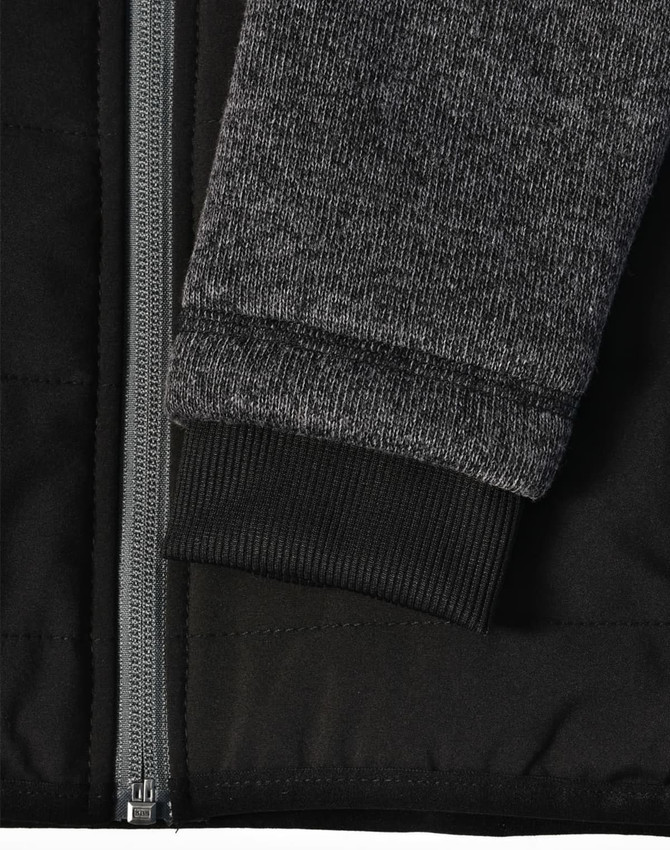 A black quilted body jacket with a heather grey sleeve and ribbed cuffs, featuring a zip closure.
