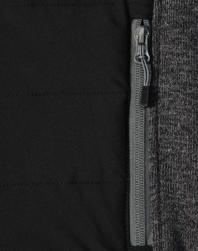 A close-up of a men's jacket featuring a heather sleeve and quilted black body with a zip pocket.