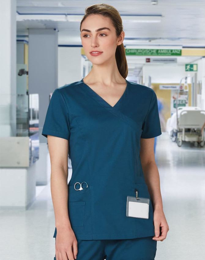 A solid teal short-sleeve scrub top designed for women, featuring a pocket and logo branding.