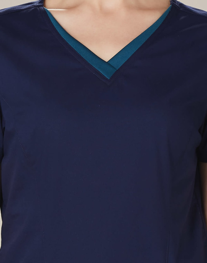 A navy scrub top featuring a contrasting teal V-neck collar and short sleeves. It has a logo on the front.