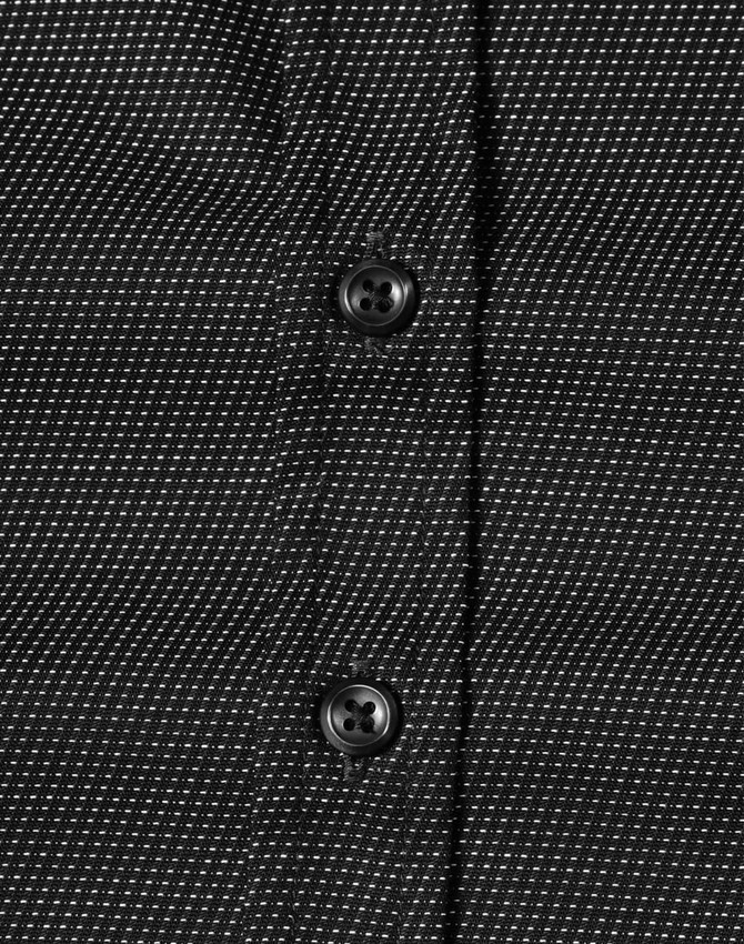 A black and white pin dot button-up shirt featuring a close-up view of buttons.