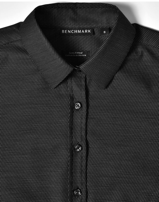 A black pin dot stretch long sleeve button-up shirt with a collar and branded tag.