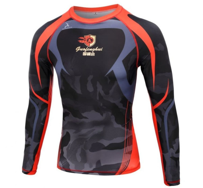 A long-sleeve compression tee featuring a red and black camo design with grey accents and a logo on the front.