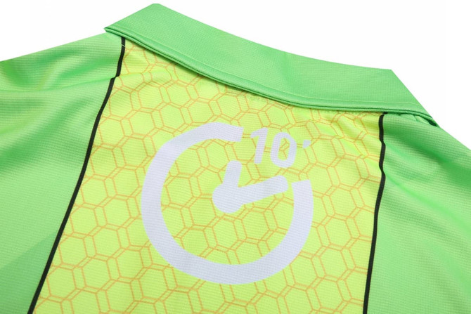 A bright lime green uniform featuring a honeycomb pattern and a circular logo on the back.