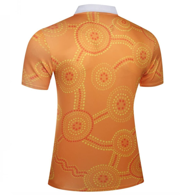 A short-sleeved shirt featuring an orange design with circular dot patterns and a white collar. It has a logo.