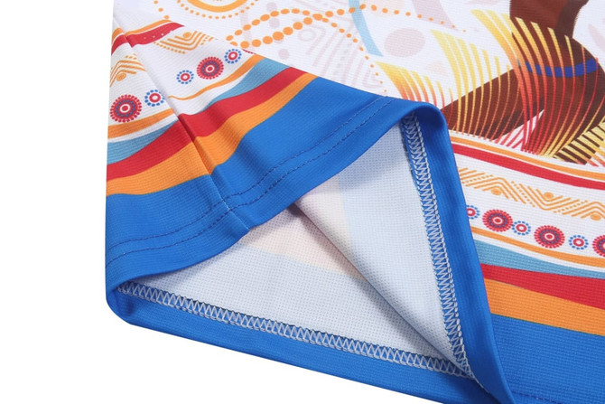A towel with a vibrant patterned design featuring blue, orange, and red colours and a stitched edge.