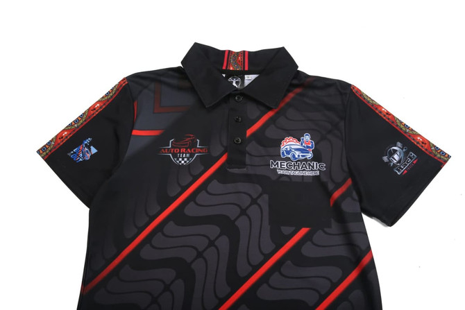 A black polo shirt with red accents, featuring multiple logos and a patterned design on the sleeves.
