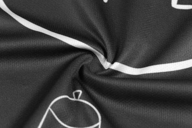 A close-up view of a black sublimation polo with a camouflage pattern and a logo.