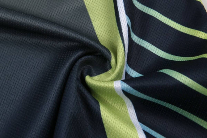 A fabric featuring a mix of dark navy blue and vibrant green with stripes, showcasing a smooth texture.