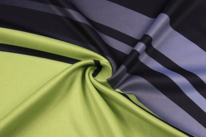 A folded fabric featuring green and navy with grey stripes, showcasing a smooth, athletic texture.