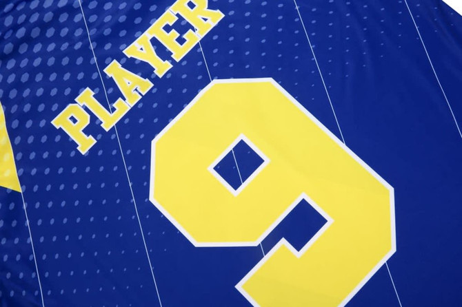 A blue polo shirt featuring a large yellow number 9 and the word "PLAYER" above it, with a logo present.
