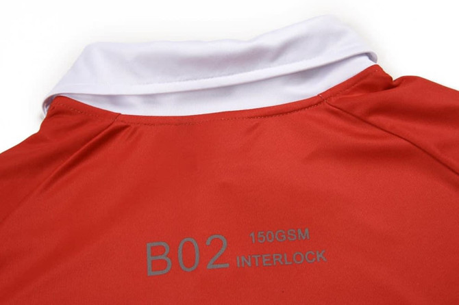 A red polo shirt with a white collar, featuring a logo on the back.
