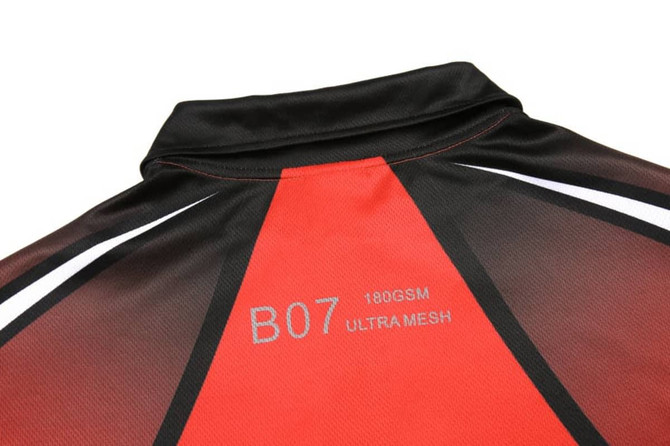 A red and black customised polo featuring a collar and a tag indicating fabric details.