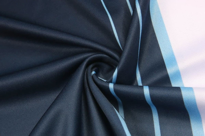 A fabric with a navy blue base and light blue stripes, arranged in a swirling pattern. It has a smooth texture.