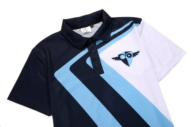 A polo shirt featuring a navy blue, light blue, and white design with a logo on the front.