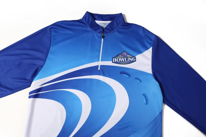 A blue and white lawn bowling uniform featuring a zip collar and a logo. The design includes wavy patterns.