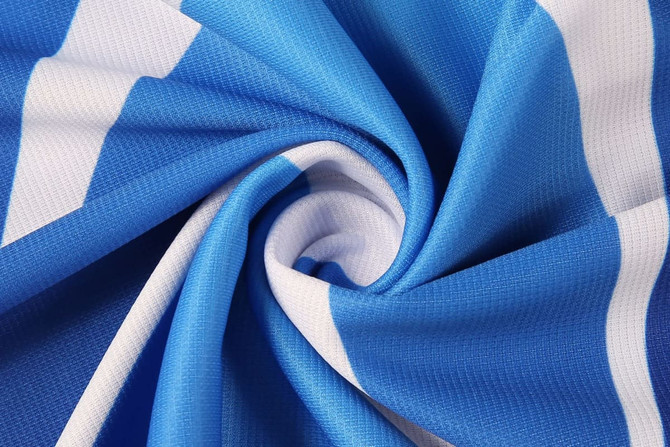 A close-up of fabric featuring blue and white stripes, showcasing the texture of the material.