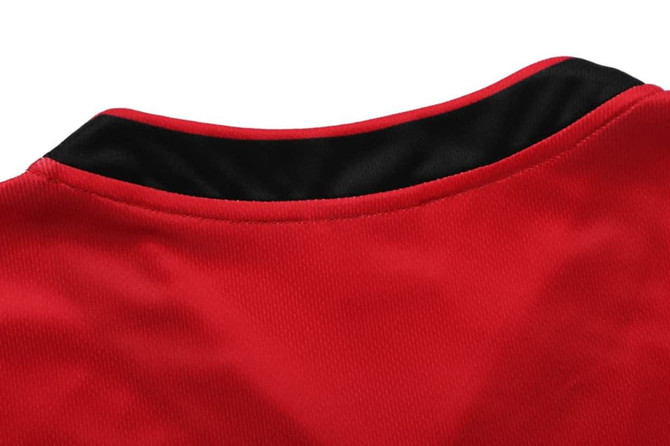 A red singlet with a black collar, featuring a smooth fabric texture and no visible logos.