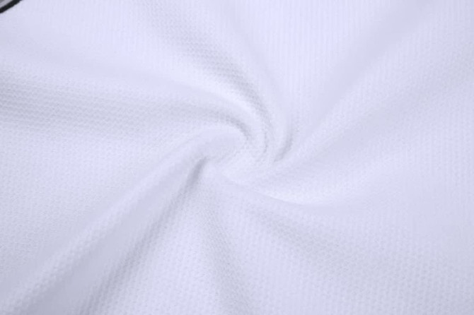 A sleeveless baseball singlet made of white textured fabric, featuring a logo on the design.