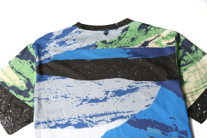 A custom-made printing cotton tee featuring a multicoloured abstract design with blue, green, and black patterns.