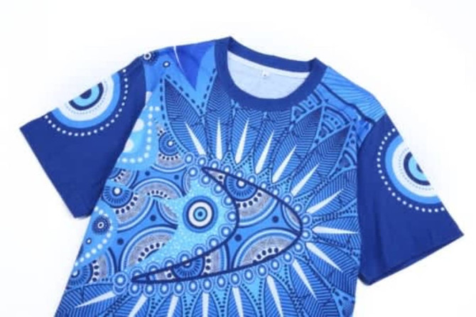 A blue Aboriginal cotton t-shirt featuring intricate geometric patterns and a logo.