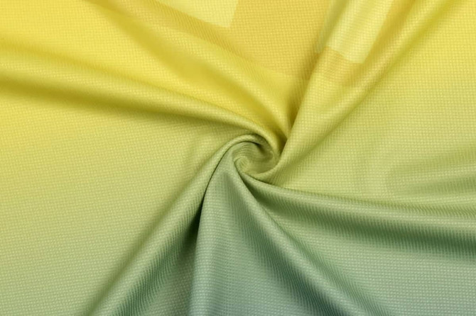 A textured fabric in a gradient of yellow and light green tones, featuring a subtle pattern.