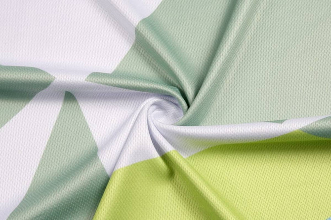 A fabric featuring bold patterns in green and white, showcasing a breathable mesh texture.