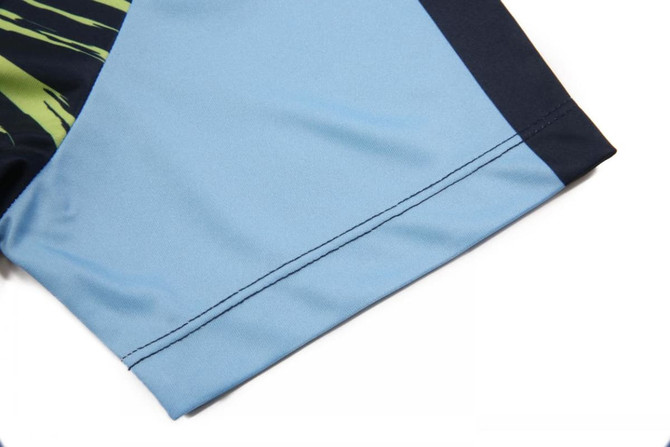 A blue shirt sleeve featuring a green and black design with a sleek finish. It includes a logo on the fabric.