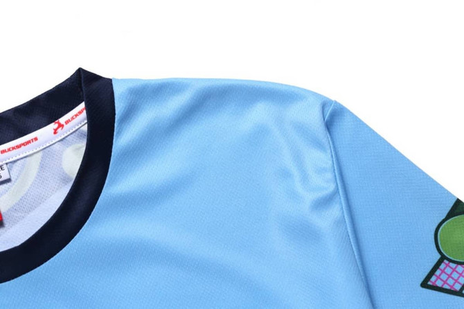 A light blue soccer polo featuring a black collar and a logo on the design.