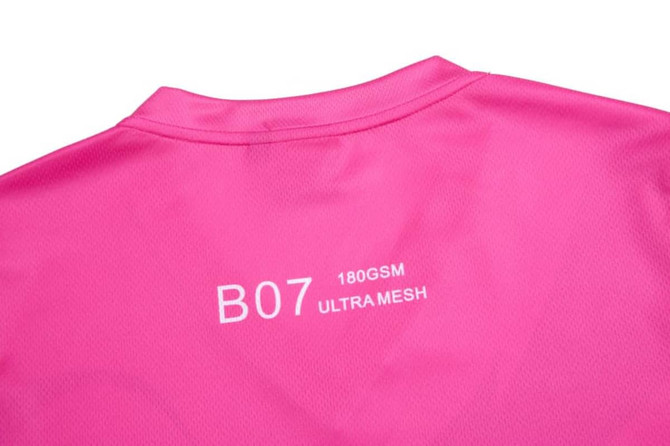 A vibrant pink cheerleader uniform with a smooth texture and branding on the back.